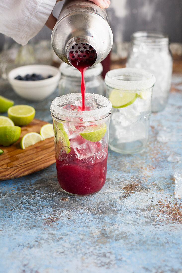 Margaritas with blueberry juice and lime