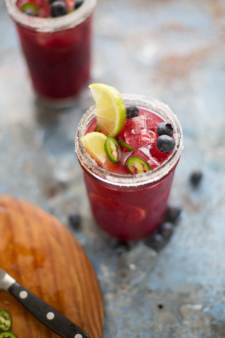 Margaritas with blueberries, chillies and lime