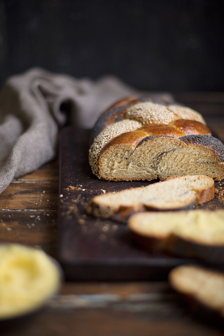 Braided bread with poppy seeds and sesame seeds, sliced