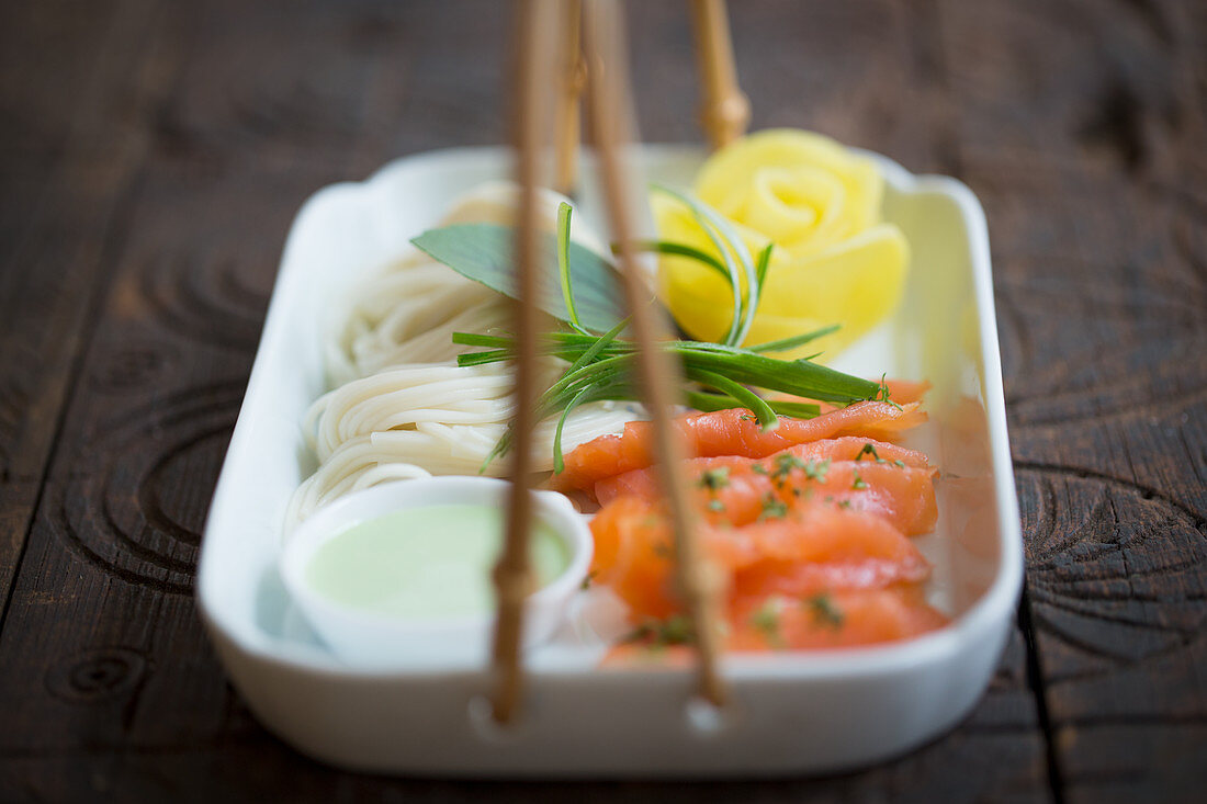 Salmon and noodles with a radish rose and wasabi (Japan)