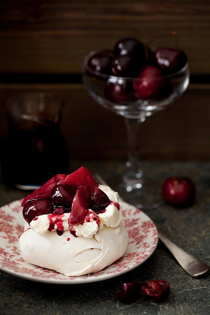 Meringue Nest with Cream, Poached Pears and Cherries