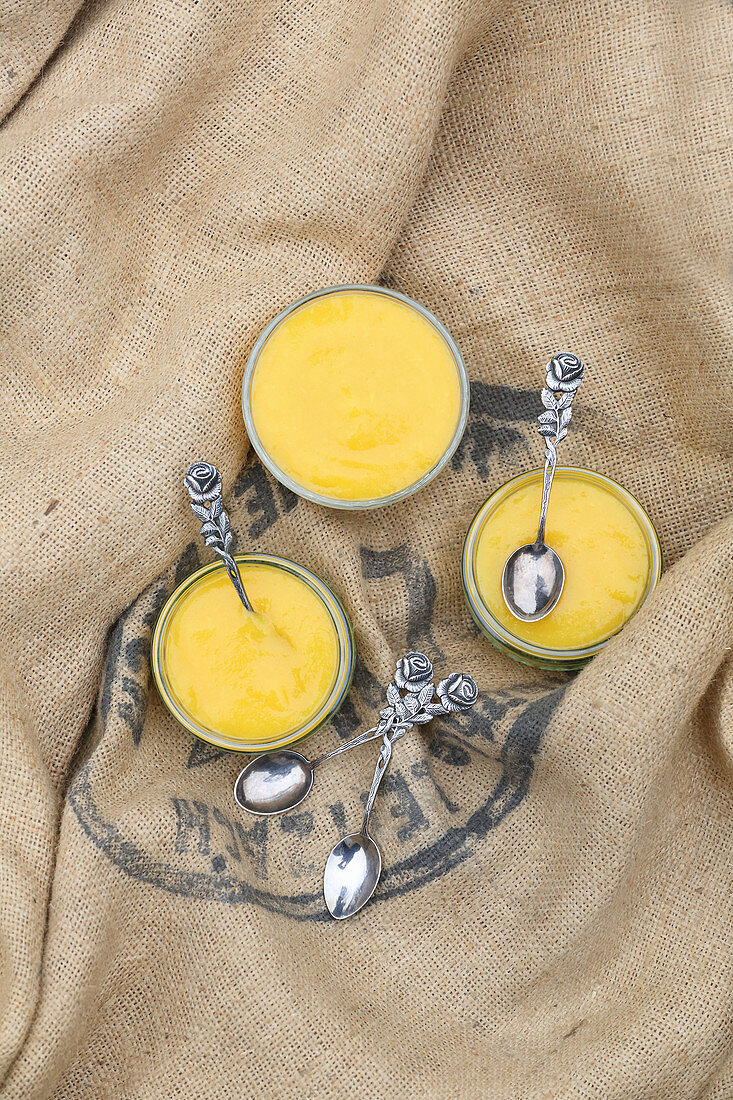Bavarian cream with mango puree in glass bowls on a sackcloth