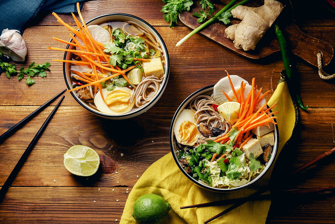 Miso ramen soup with shiitake mushrooms, fried tofu, carrots, cabbage, leek and lime (Asia)