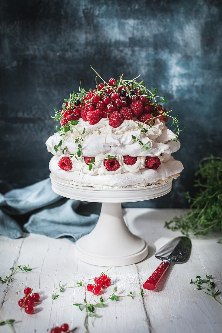 Baisertorte mit Sahne, Himbeeren, roten Johannisbeeren und Thymian