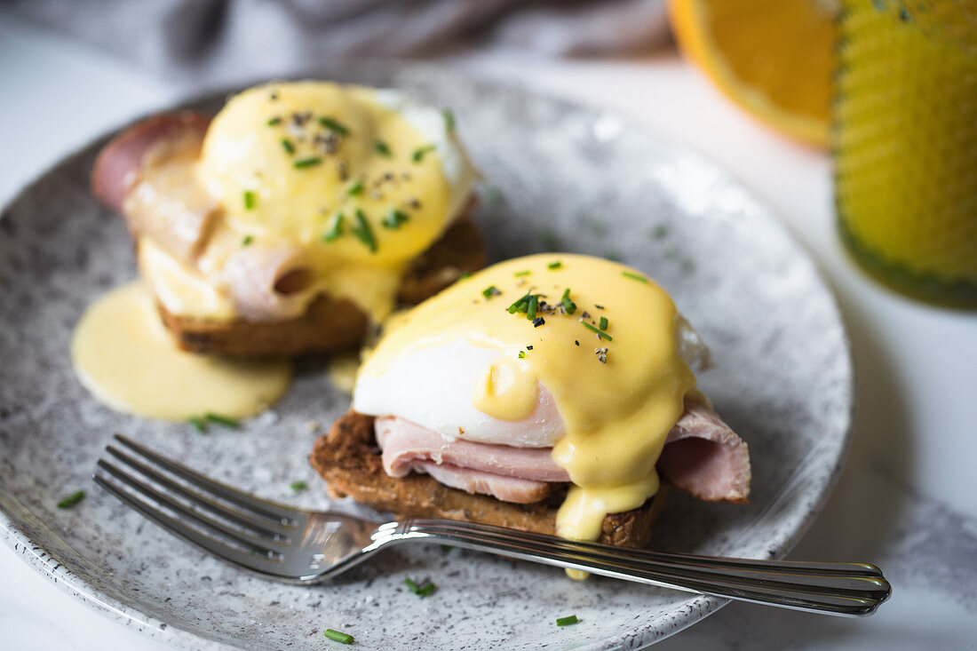 Breakfast dish of ham, poached eggs and hollandaise sauce