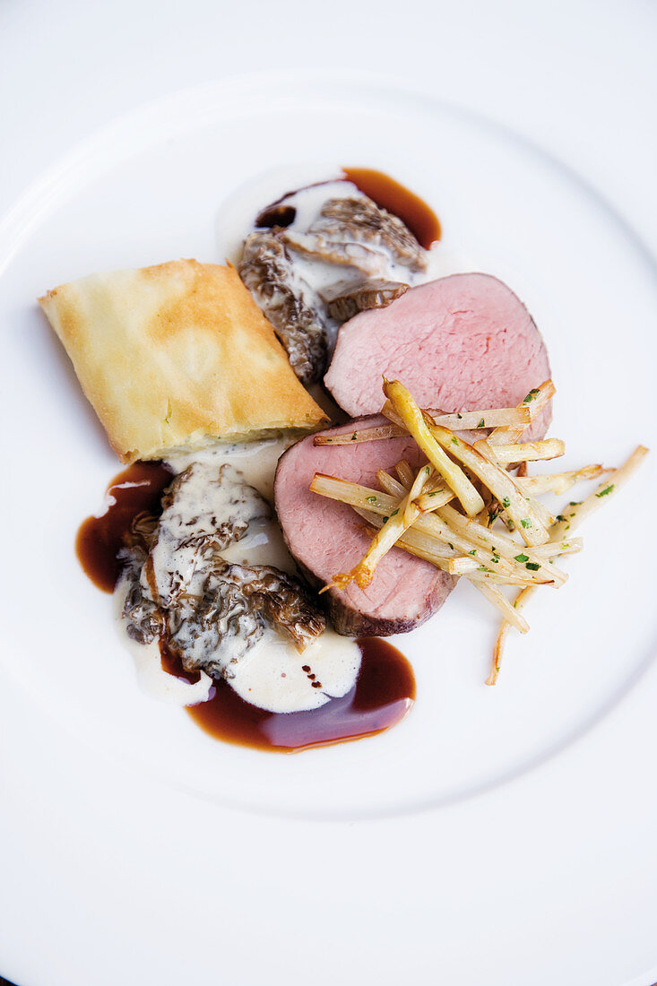 Veal fillets on morel ragout with asparagus strudel and fried asparagus sticks