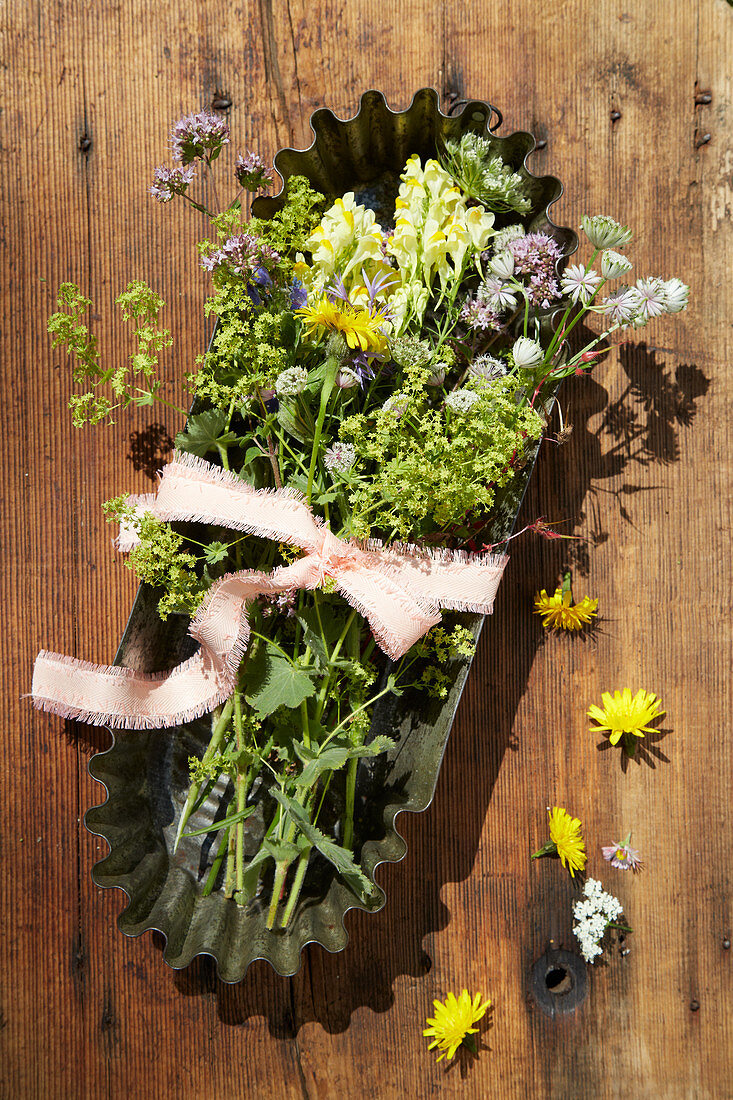 Wildflowers in vintage cake tin decorating table