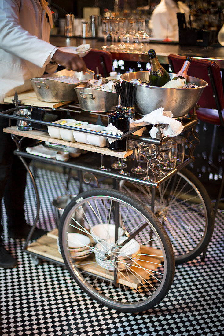 A serving trolley with ingredients for cocktails and drinks
