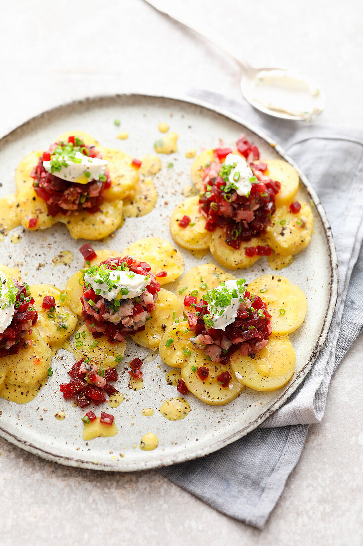 Potato slices with herring and beetroot tatar