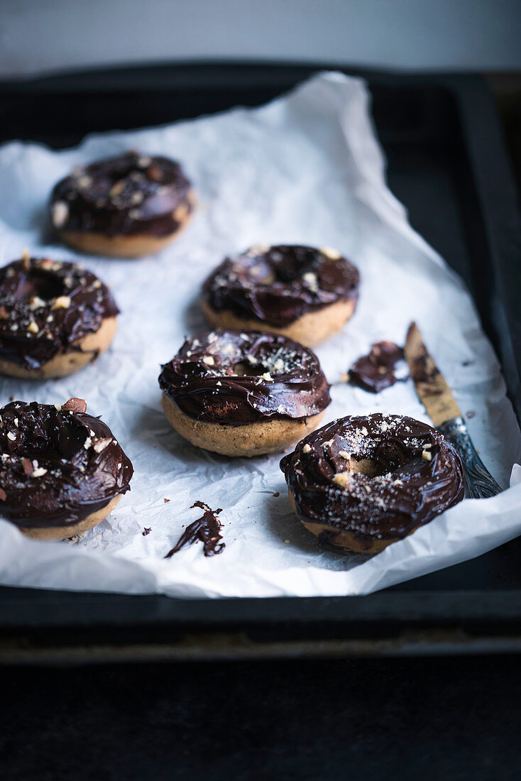 Vegan coffee and hazelnut doughnuts with chocolate glaze
