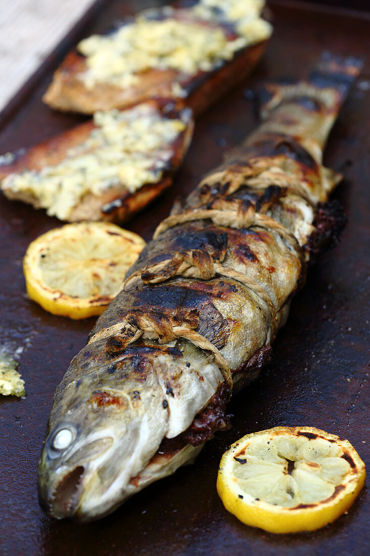 A grilled whole trout filled with black pudding
