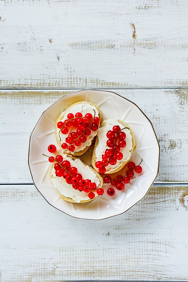 Sweet crostinis sandwiches with cheese and fresh red currants