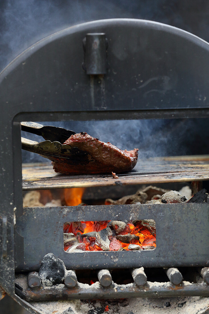 A flat iron steak on a grill
