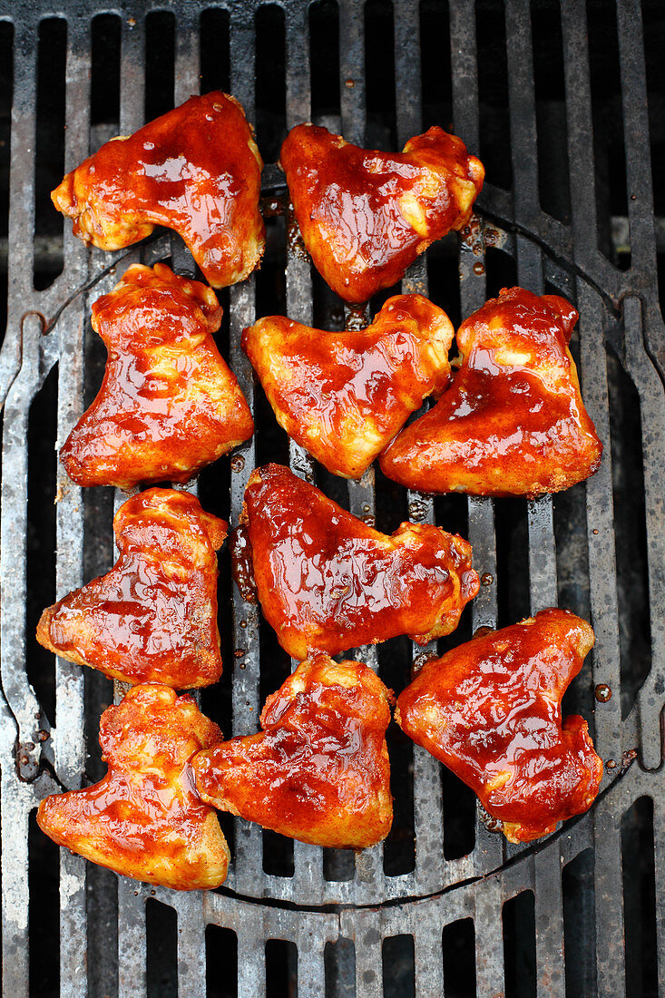 Sweet and sour chicken wings on a grill