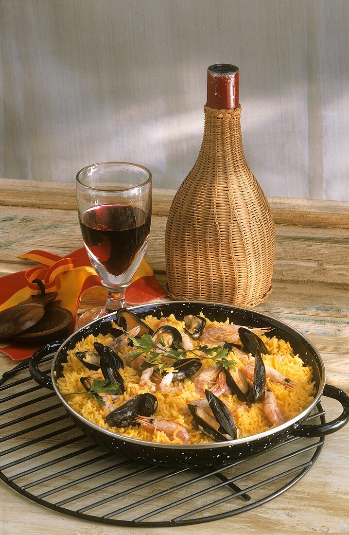Paella in Pan; Red Wine Decanter and Glass