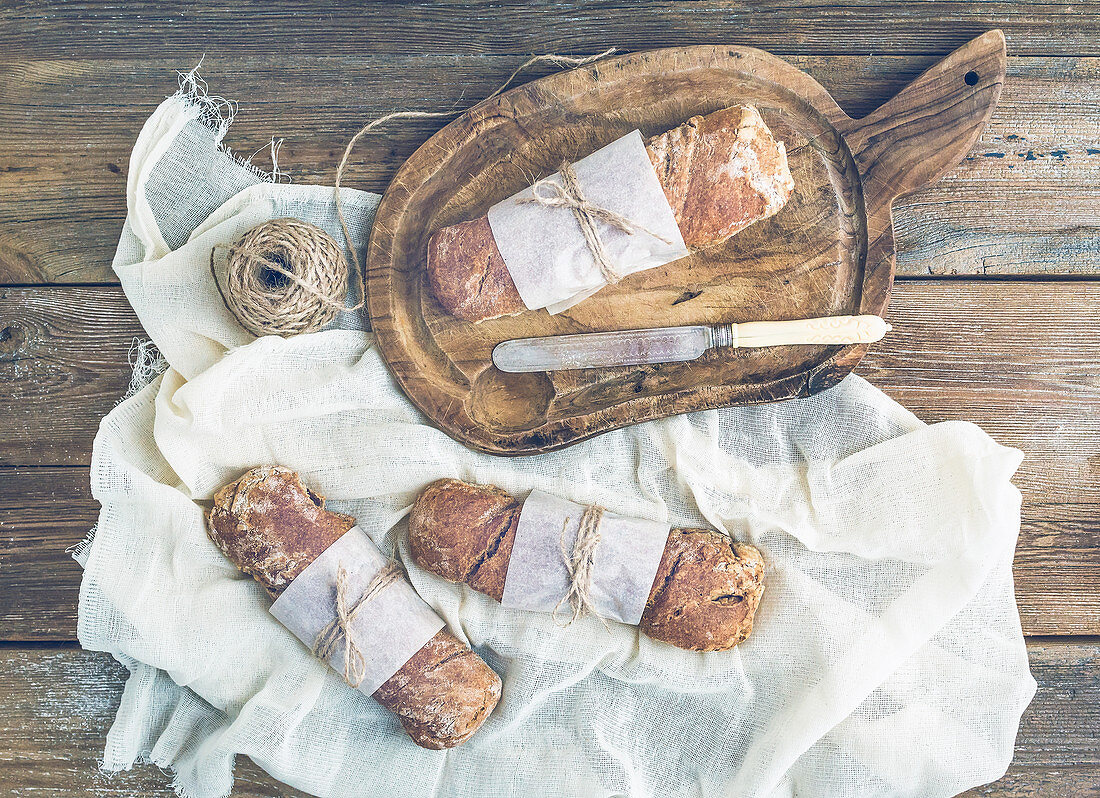 Freshly baked rustic village bread (baguettes) wrapped in paper