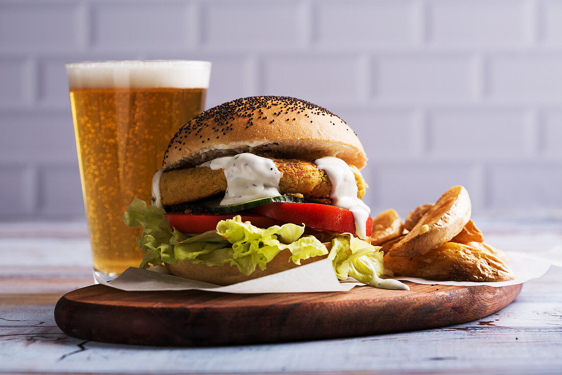 Vegetarian chickpea burger, with fries and a glass of beer