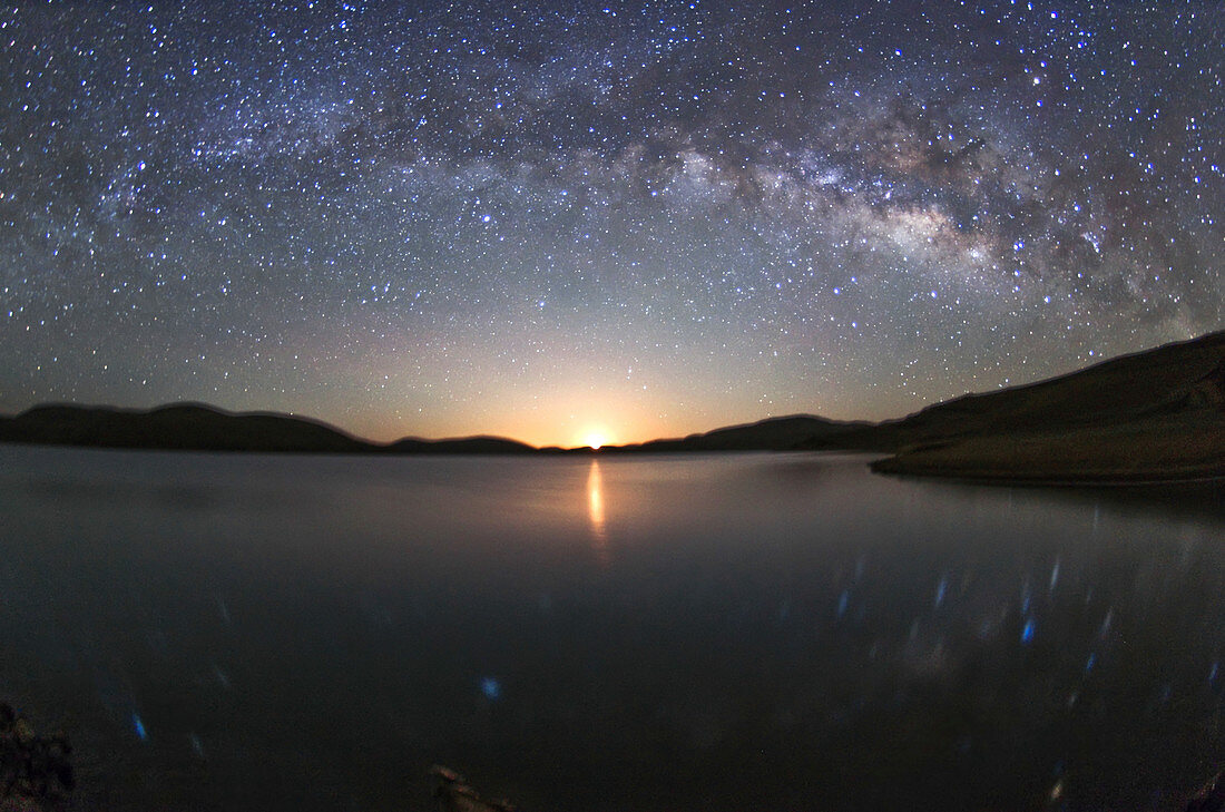 Milky Way over lake at moonrise