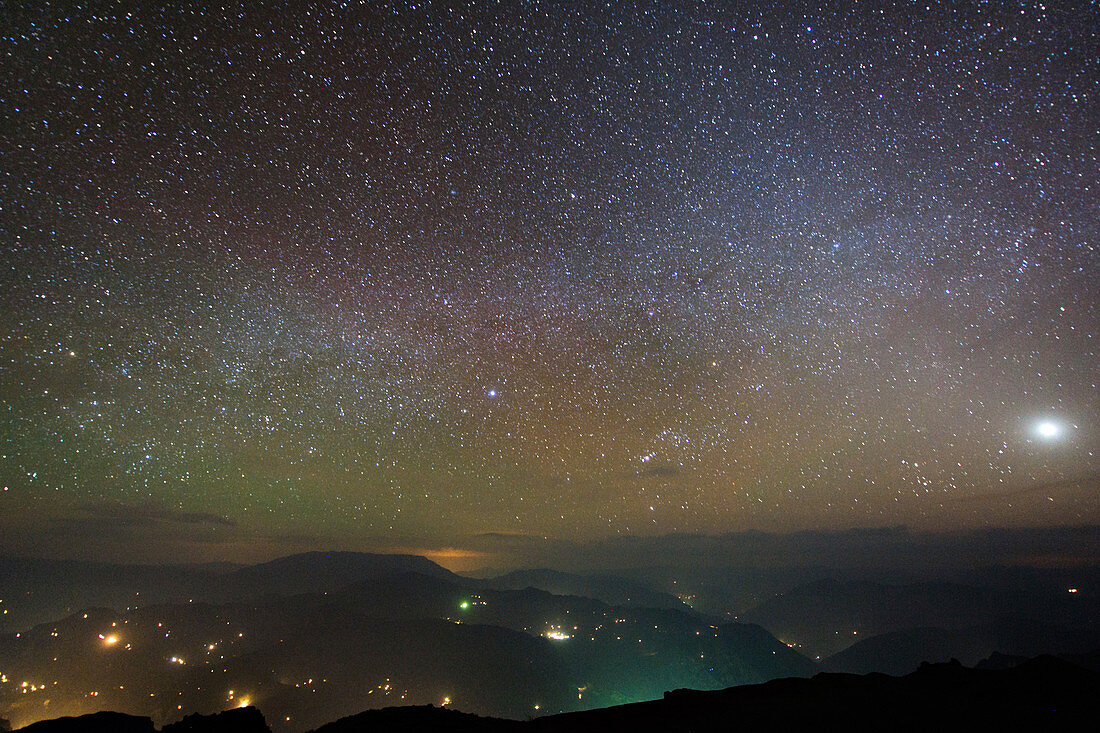 Night sky and airglow over hills