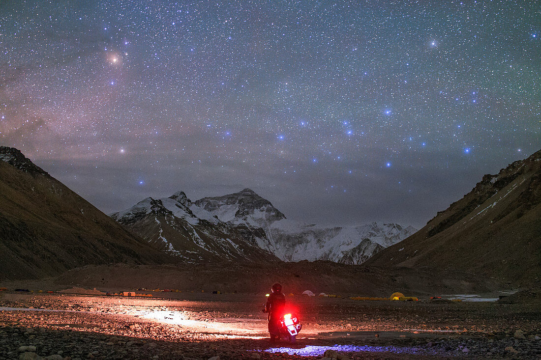 Motorcyclist and Mount Everest at night