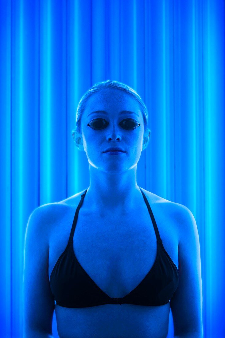 Woman in tanning booth