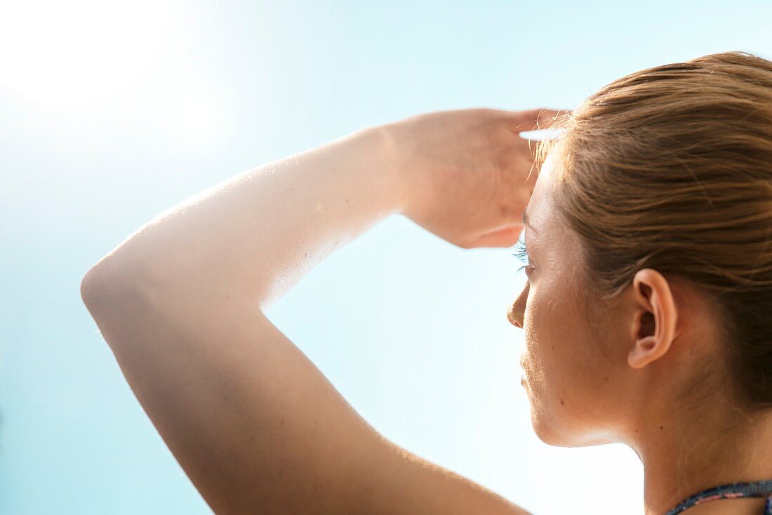 Woman shielding her eyes from the sun