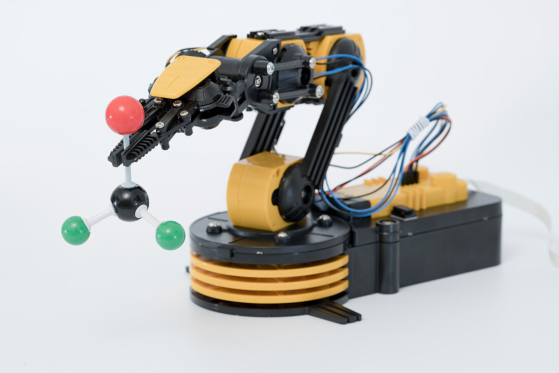 Robotic arm holding molecular model
