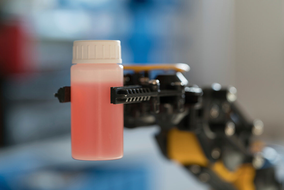 Robotic arm holding bottle
