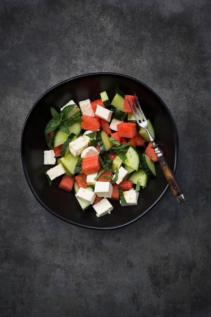 Watermelon salad with feta cheese, cucumbers, mint and lime dressing