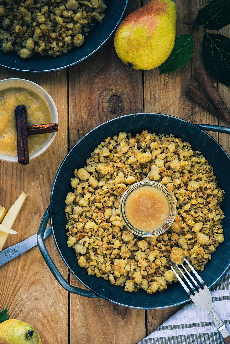 Grissons Maluns (fried mashed potatoes) with pear compote in a cast iron pan