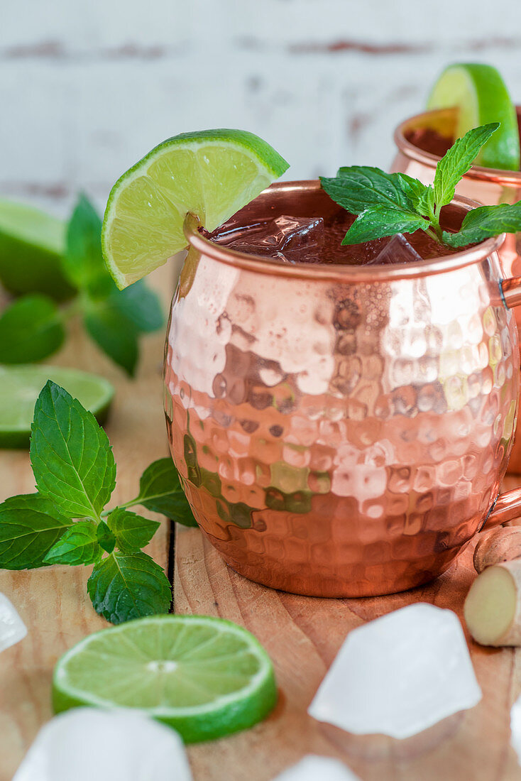 A Moscow Mule in a copper mug with mint and lime