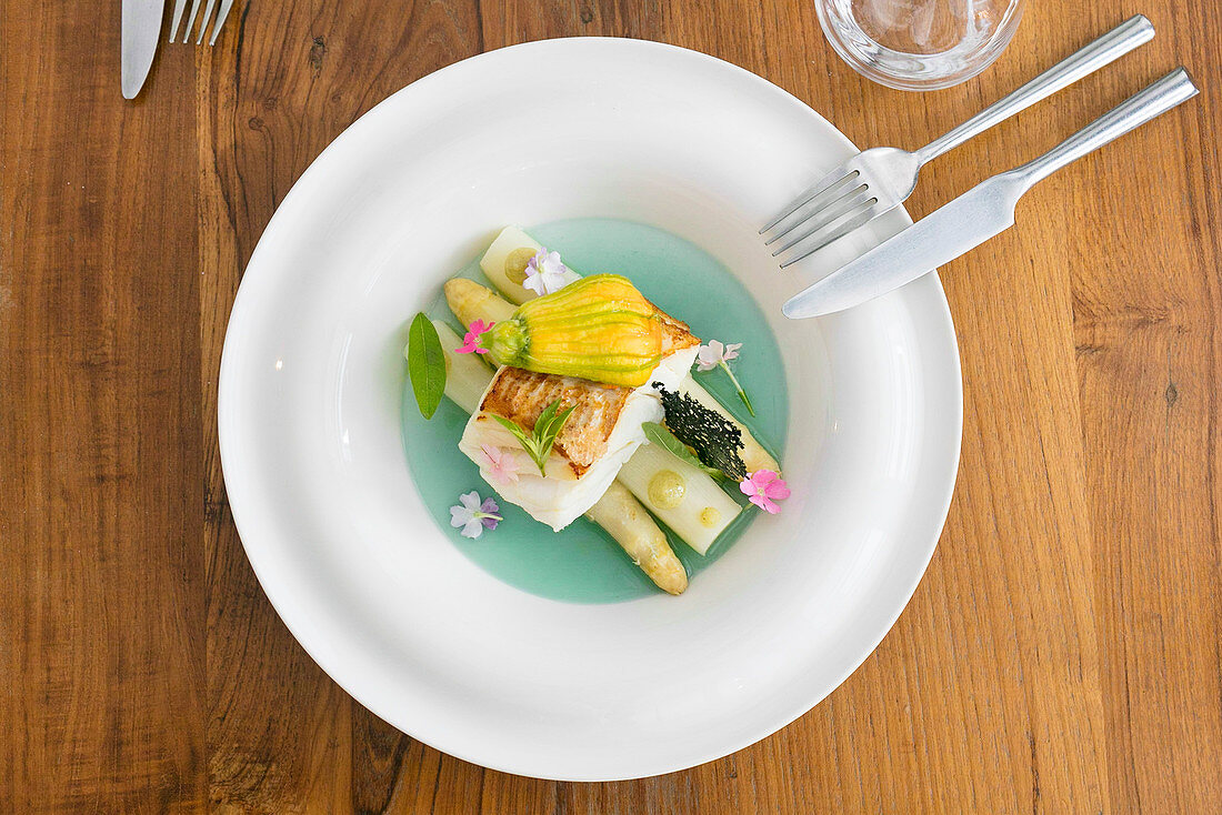 White asparagus with fish and a stuffed courgette flower