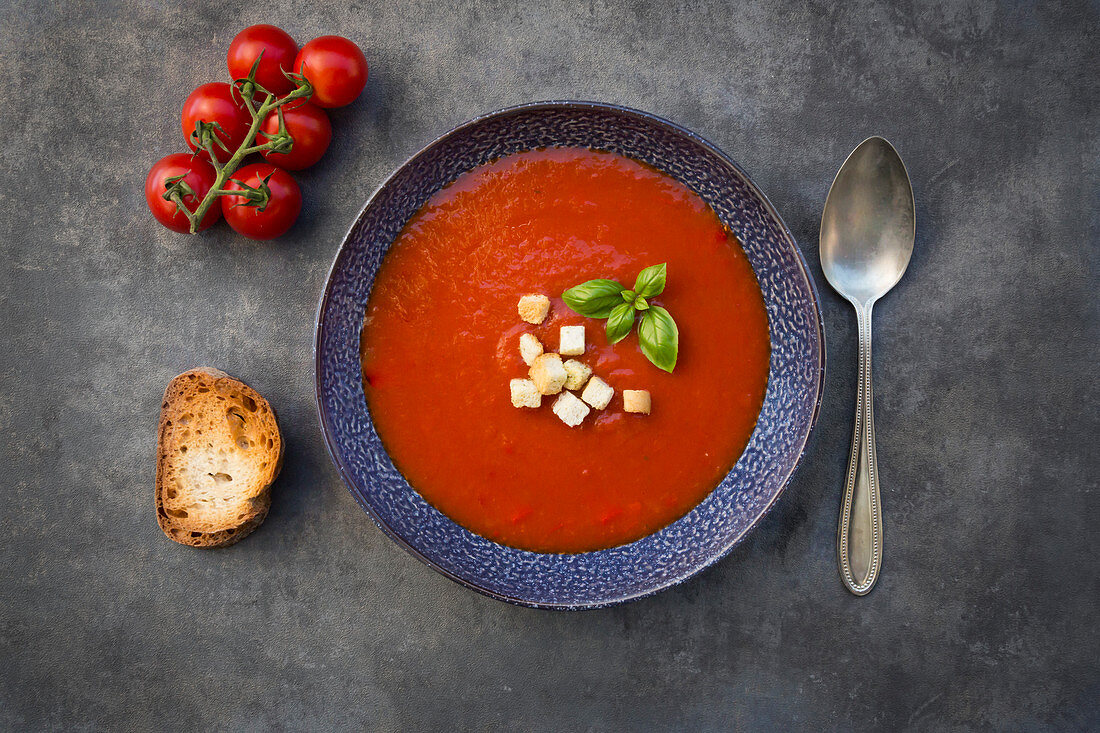 Tomato soup with basil, croutons and grilled baguette