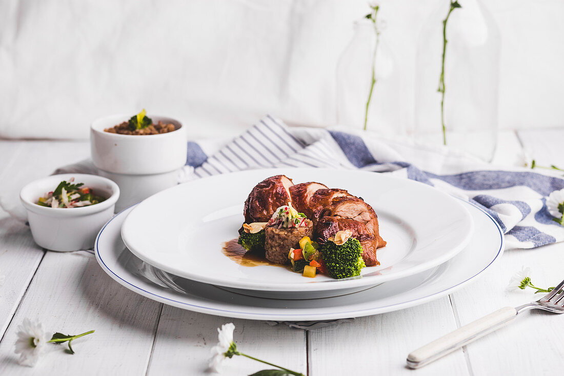 Pork roulade with grain timbale and broccoli