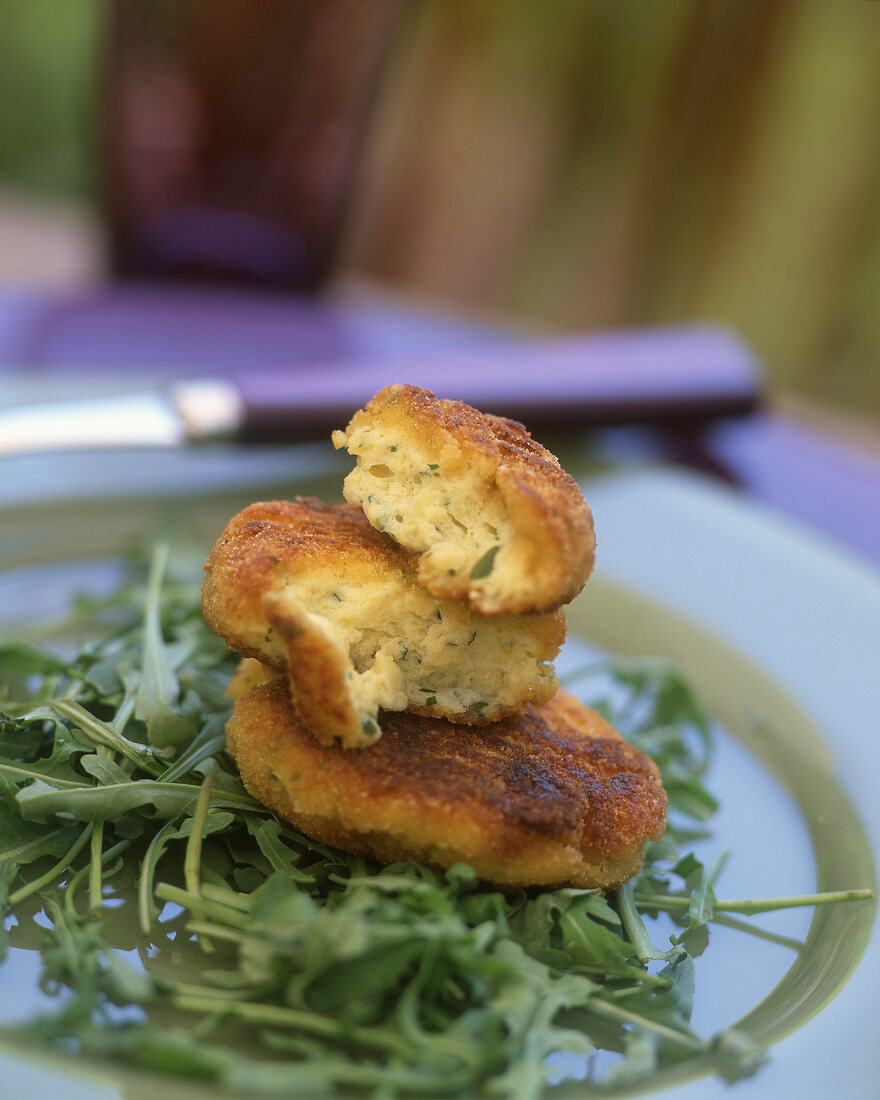 Potato and egg beignets on rocket