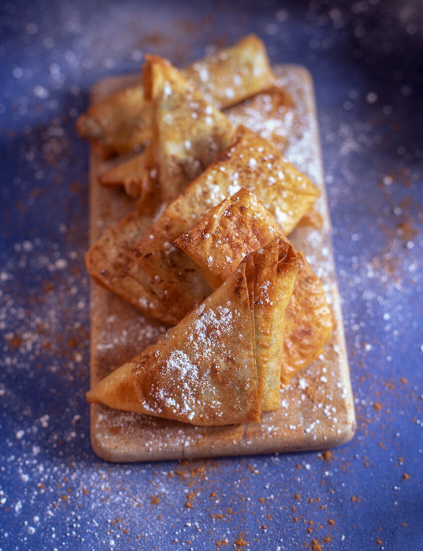 Puff pastry turnovers with cinnamon and icing sugar