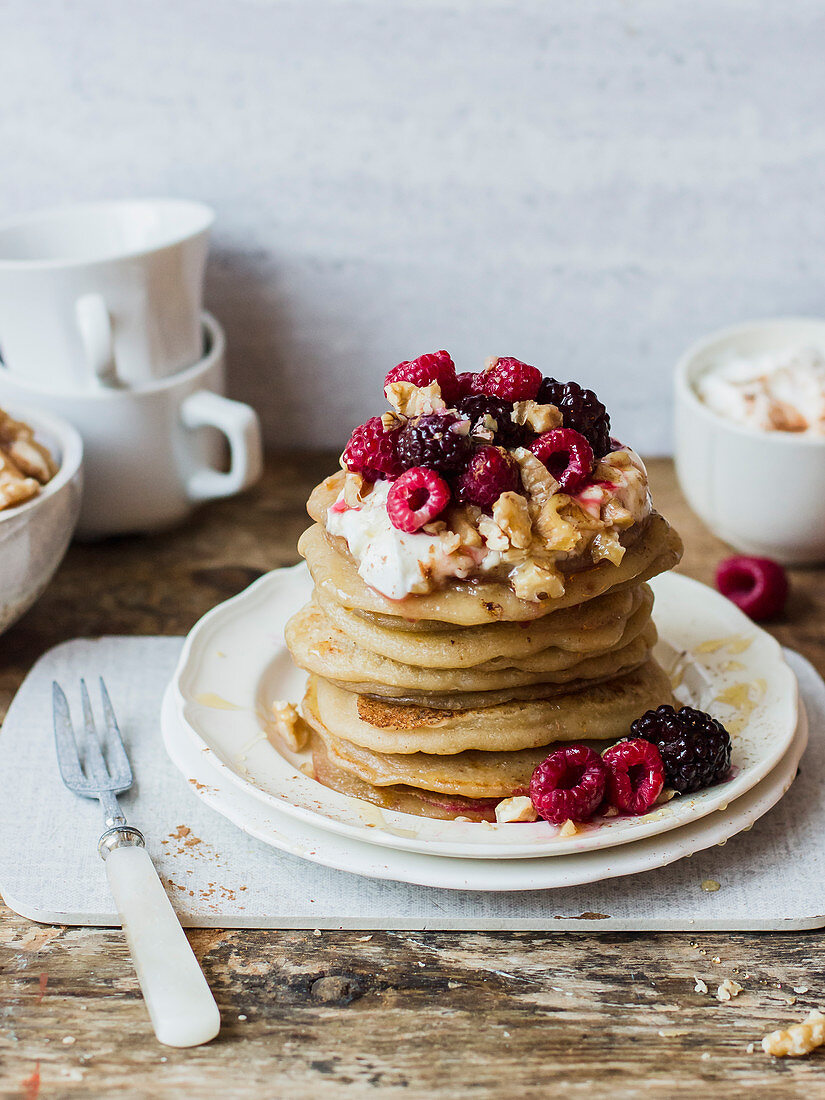 Greek pancakes with yogurt, raspberries, blackberries, walnuts and honey