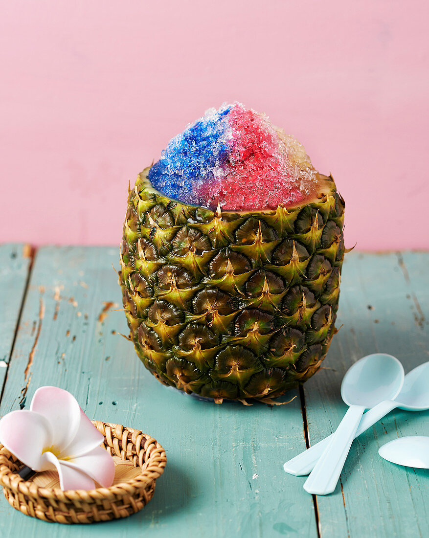 A pineapple filled with flower petal granita