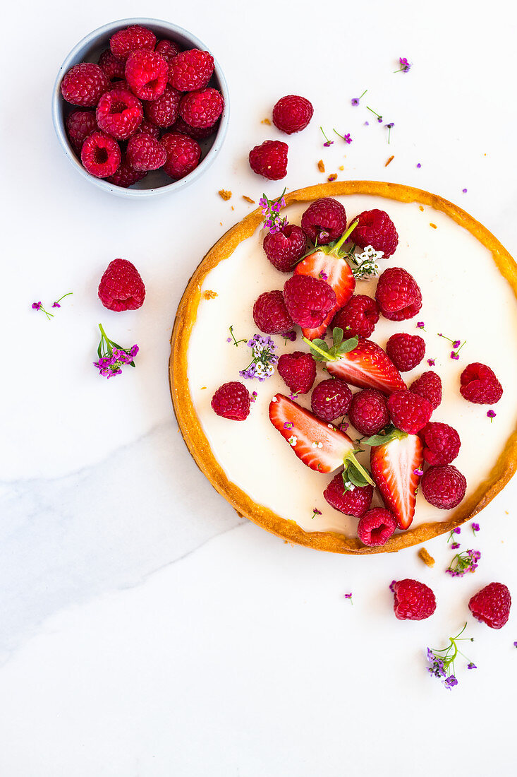 A berry tart with raspberries and strawberries