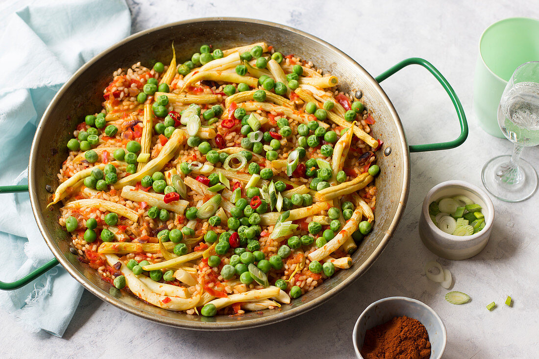 Vegetarische Paella mit Erbsen, gelben Bohnen, Chilischoten, Frühlingszwiebeln und Räucherpaprika