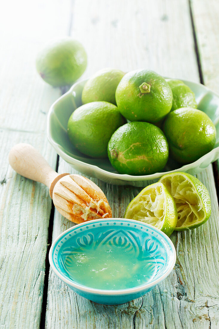 Lime juice, fresh limes and a juicer