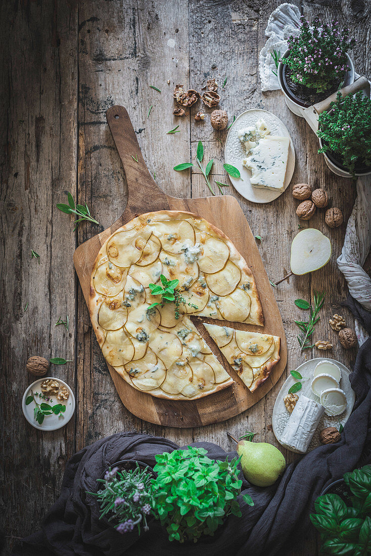 Pear and Gorgonzola homemade Pizza on a rustic wooden background