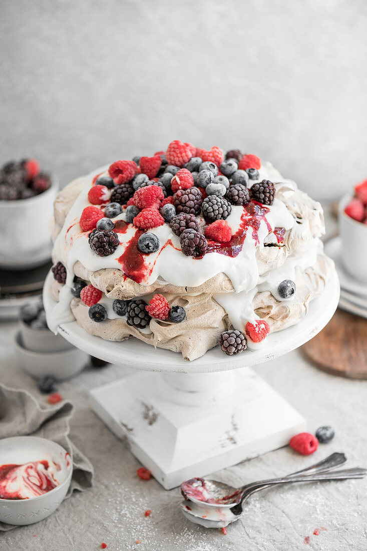 Cacao Cream Pavlova Cake made with chocolate meringue and topped with fresh fruit