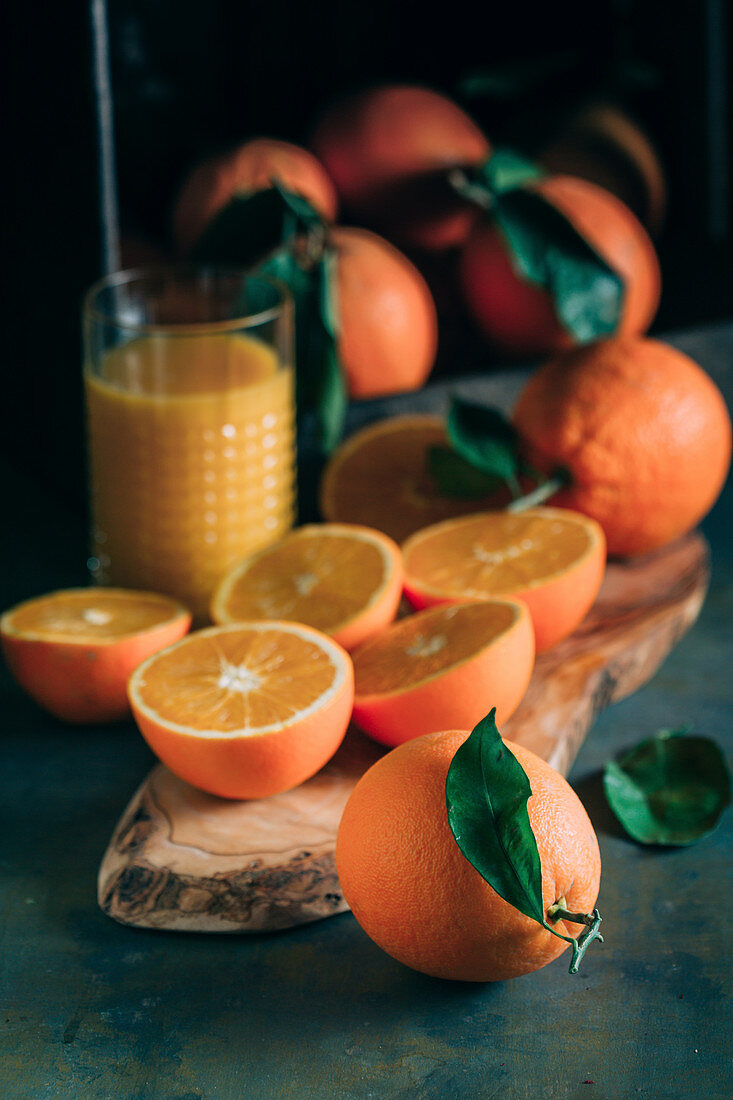 Fresh oranges and glass with orange juice