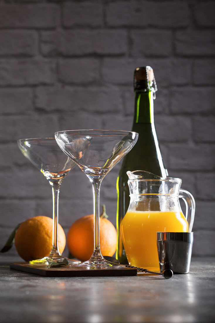 Preparing mimosa cocktail with champagne and orange juice