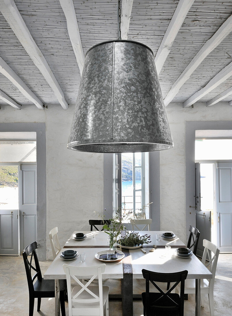Zinc lampshade in country-house-style dining room