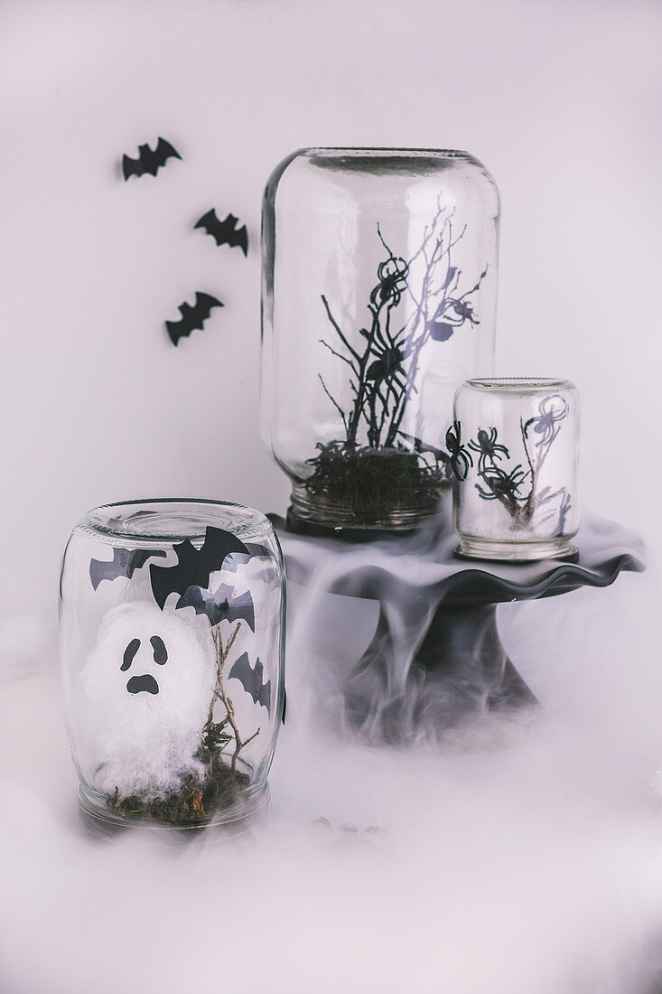 Halloween decorations handmade from jars, branches and cotton wool