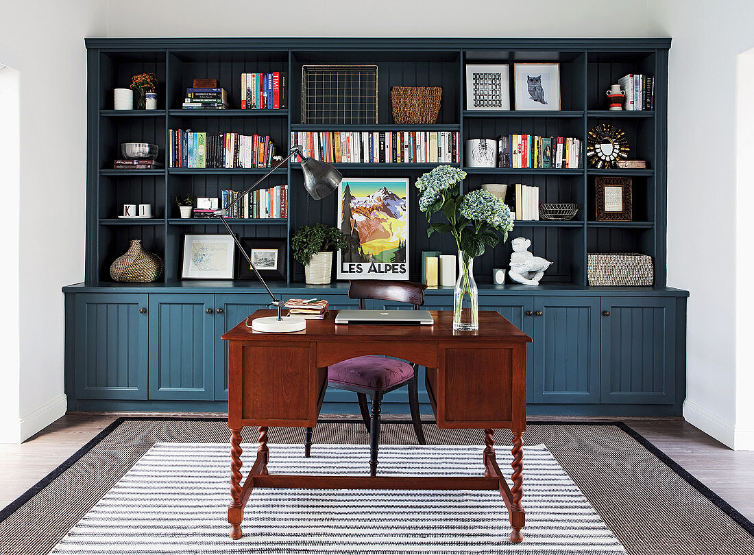 Antique desk in front of bookcase in study