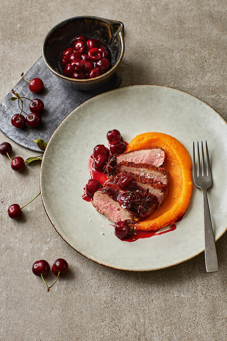Fried duck breast with butternut squash and cherries