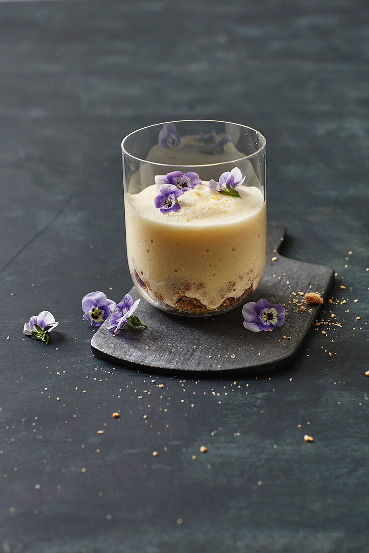 Berlin cheesecake in a glass with lemon salt and tufted pansies